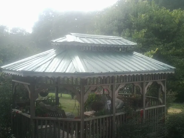 Two tier green metal roof on a garden gazebo in Arlington